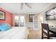 Cozy bedroom with light walls, white bedding, and a work space at 74 Gulf Blvd # 2B, Indian Rocks Beach, FL 33785