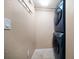 Laundry room with stacked washer and dryer units and tile flooring at 74 Gulf Blvd # 2B, Indian Rocks Beach, FL 33785