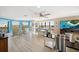 Spacious living room with dining area, large windows, and coastal decor at 74 Gulf Blvd # 2B, Indian Rocks Beach, FL 33785