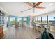 Bright living room with bay windows, a dining area, and beautiful waterfront views at 74 Gulf Blvd # 2B, Indian Rocks Beach, FL 33785