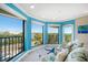 Bright living room with coastal decor and wide windows offering water views at 74 Gulf Blvd # 2B, Indian Rocks Beach, FL 33785