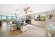 Inviting open-concept living space with modern furnishings and scenic water views from large windows at 74 Gulf Blvd # 2B, Indian Rocks Beach, FL 33785