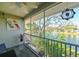 Peaceful screened balcony overlooking a tranquil lake with a fountain, offering a relaxing outdoor retreat with scenic views at 8350 Savannah Trace Cir # 1808, Tampa, FL 33615