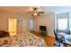 Inviting bedroom with a study, ceiling fan, and views into the bathroom at 8350 Savannah Trace Cir # 1808, Tampa, FL 33615