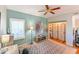 Well-lit bedroom with a ceiling fan, natural light, and convenient closet space at 8350 Savannah Trace Cir # 1808, Tampa, FL 33615