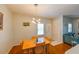 Cozy dining room with hardwood floors, modern lighting fixture, and hallway closet at 8350 Savannah Trace Cir # 1808, Tampa, FL 33615