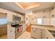 Charming kitchen offers stainless appliances, bright white cabinetry, and tiled floor at 8350 Savannah Trace Cir # 1808, Tampa, FL 33615
