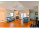Bright living room with hardwood floors, fireplace, ceiling fan, and access to outdoor patio at 8350 Savannah Trace Cir # 1808, Tampa, FL 33615