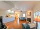 Open concept living room with hardwood floors, fireplace, and view to kitchen area at 8350 Savannah Trace Cir # 1808, Tampa, FL 33615