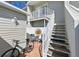 Relaxing patio with outdoor seating, accessed by a staircase, featuring a charming bistro set for enjoying the fresh air at 8350 Savannah Trace Cir # 1808, Tampa, FL 33615
