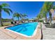 Fenced community pool with lounge chairs and palm trees offers a relaxing outdoor space at 8350 Savannah Trace Cir # 1808, Tampa, FL 33615