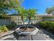A shady pool-side seating area with seating provides a relaxing community space at 8350 Savannah Trace Cir # 1808, Tampa, FL 33615