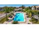 Community pool surrounded by palm trees and lounge chairs perfect for relaxation and recreation at 8350 Savannah Trace Cir # 1808, Tampa, FL 33615