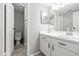 Bright bathroom with white cabinets, vanity, sink, and toilet at 9100 Dr Martin Luther King Jr N St # 1508, St Petersburg, FL 33702