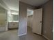 Bright bedroom featuring wood-look flooring, an ensuite bathroom, and a walk-in closet with ample storage at 9100 Dr Martin Luther King Jr N St # 1508, St Petersburg, FL 33702