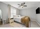 Well-lit bedroom with ceiling fan, decor rug, and an ensuite at 9100 Dr Martin Luther King Jr N St # 1508, St Petersburg, FL 33702