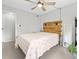Bright and airy bedroom featuring a wooden headboard, ceiling fan, and ample space at 9100 Dr Martin Luther King Jr N St # 1508, St Petersburg, FL 33702