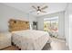 Inviting bedroom with a rustic wooden headboard, a ceiling fan, and lots of natural light at 9100 Dr Martin Luther King Jr N St # 1508, St Petersburg, FL 33702