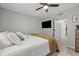 Airy bedroom with ensuite, ceiling fan, and a mounted television at 9100 Dr Martin Luther King Jr N St # 1508, St Petersburg, FL 33702