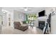 Cozy living room with fireplace, mounted TV, slider to lanai and lots of houseplants at 9100 Dr Martin Luther King Jr N St # 1508, St Petersburg, FL 33702