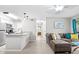 Bright living space features a granite countertop, stainless steel appliances, and a view into the hallway and bedroom at 9100 Dr Martin Luther King Jr N St # 1508, St Petersburg, FL 33702
