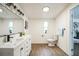 Bright bathroom showcasing a dual sink vanity, modern fixtures, and wood look flooring at 9350 Peony St, New Port Richey, FL 34654