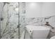 Modern bathroom featuring a stylish glass shower, soaking tub, and marble accent wall for a spa-like experience at 102 Adriatic Ave, Tampa, FL 33606