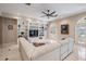 Spacious living room with a large built-in shelving unit and white tile flooring at 102 Adriatic Ave, Tampa, FL 33606