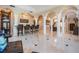 Expansive living space with marble flooring, columns, dining area, and bar at 102 Adriatic Ave, Tampa, FL 33606