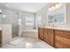 A spacious main bathroom with a glass shower, soaking tub, and double vanity at 102 Adriatic Ave, Tampa, FL 33606