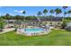 Aerial view of the community pool, clubhouse, and golf course showcasing the luxurious amenities and beautiful landscaping at 10237 Collar Dr, San Antonio, FL 33576