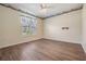 Bedroom with vinyl floors, a ceiling fan, wallpaper border, and a large window at 10237 Collar Dr, San Antonio, FL 33576