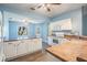 Galley style kitchen featuring white appliances and wood floors, seamlessly connected to other living spaces at 10237 Collar Dr, San Antonio, FL 33576