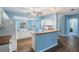 Open concept kitchen featuring white appliances and wood floors, seamlessly connected to other living spaces at 10237 Collar Dr, San Antonio, FL 33576