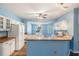 Well-lit open kitchen features white cabinets, ample counter space, a ceiling fan, and a casual dining area at 10237 Collar Dr, San Antonio, FL 33576
