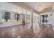 Spacious sunroom with wood floors and abundant natural light, perfect for relaxation and entertaining guests at 10237 Collar Dr, San Antonio, FL 33576