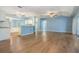 Spacious living room featuring stylish flooring, light blue walls, and sliding glass doors to lanai at 10237 Collar Dr, San Antonio, FL 33576