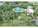 Aerial view of community amenities including pools, splash pad, and recreational facilities surrounded by lush greenery at 10432 High Noon Trl, Parrish, FL 34219