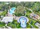 Overhead shot of community amenities including pool, splashpad and playground surrounded by lush landscaping at 10432 High Noon Trl, Parrish, FL 34219