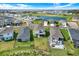 Aerial view of the home, highlighting the expansive backyard, community pool, and neighborhood layout at 10432 High Noon Trl, Parrish, FL 34219