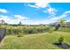 Backyard features lush greenery, a fence, and views of the surrounding natural landscape and community at 10432 High Noon Trl, Parrish, FL 34219