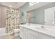 Bathroom with double sink vanity and bathtub with tile surround and decorative shower curtain at 10432 High Noon Trl, Parrish, FL 34219