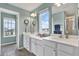 Dual vanity bathroom with sinks, mirrors, and neutral tones at 10432 High Noon Trl, Parrish, FL 34219