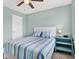 Comfortable bedroom with a ceiling fan, window, and tasteful coastal-themed decor at 10432 High Noon Trl, Parrish, FL 34219