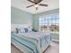 Bright bedroom with large window, ceiling fan, and stylish nautical-themed decor at 10432 High Noon Trl, Parrish, FL 34219