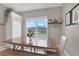 Dining room with wooden table, bench seating, and natural light at 10432 High Noon Trl, Parrish, FL 34219