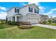 Two-story home with a two car garage, blue shutters, well manicured lawn and stone accents at 10432 High Noon Trl, Parrish, FL 34219