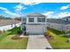 Charming two-story home with a well-maintained lawn, mature landscaping, and inviting curb appeal at 10432 High Noon Trl, Parrish, FL 34219
