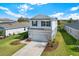 Attractive two-story home with a well-manicured lawn, landscaped garden, and a welcoming driveway at 10432 High Noon Trl, Parrish, FL 34219