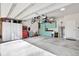 Spacious garage features overhead storage, cabinets, and ample room for vehicles and workspace at 10432 High Noon Trl, Parrish, FL 34219